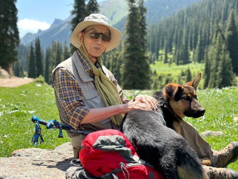 photo of Tourist with hunting dog. Nomads Life